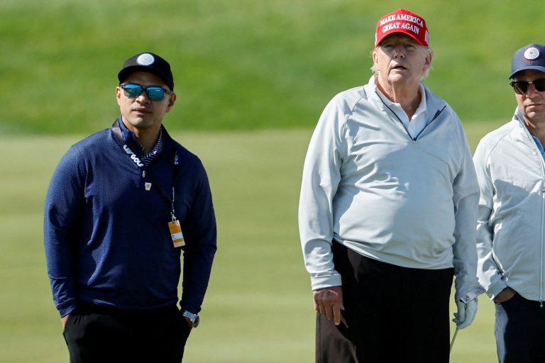Walt Nauta, personal aide to former U.S. President Trump, walks with Trump at the Trump National Golf Club in Sterling, Virginia